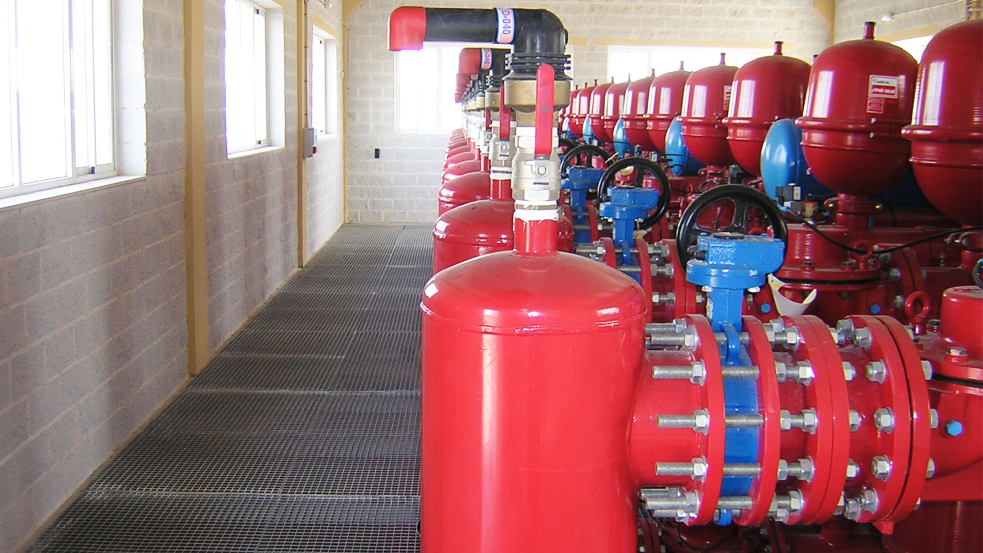 A long line of AVK air valves installed in a water treatment plant