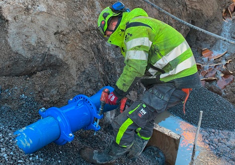 Worker drilling one-bolt couplings