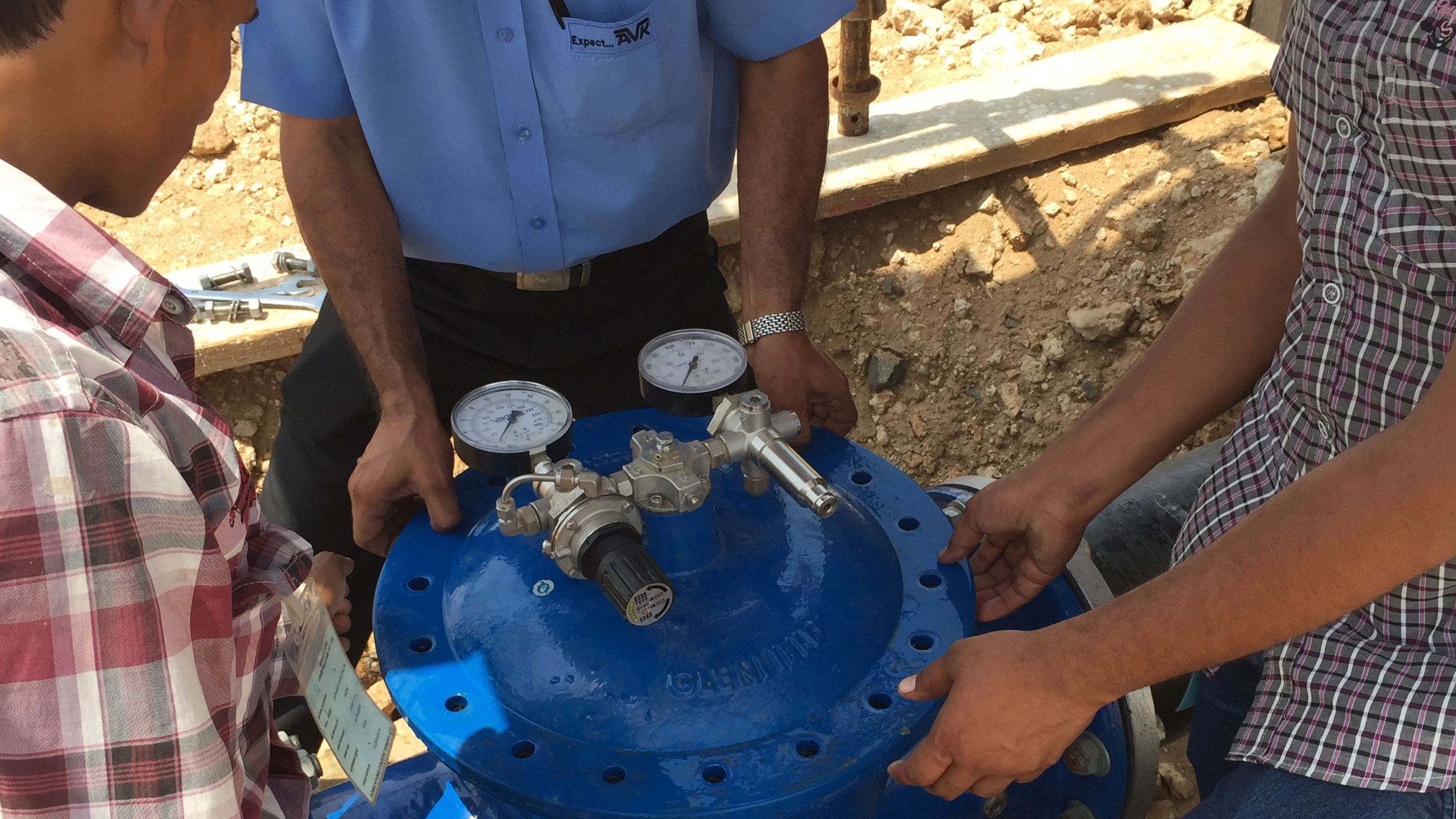 Installation of AVK control valve, close-up with hands
