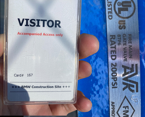 Hand holding visitor access card